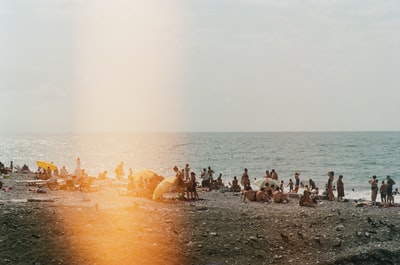 People sitting on the beach for a walk during the day
